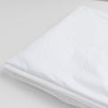Folded white waterproof bedwetting protector sheet