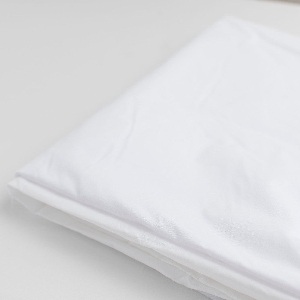 Folded white waterproof bedwetting protector sheet