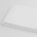 White organic sateen cotton fabric on a light background
