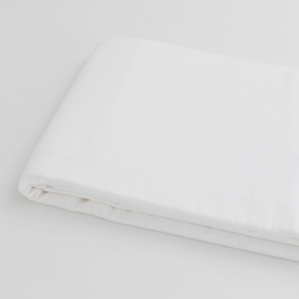 White organic sateen cotton fabric on a light background