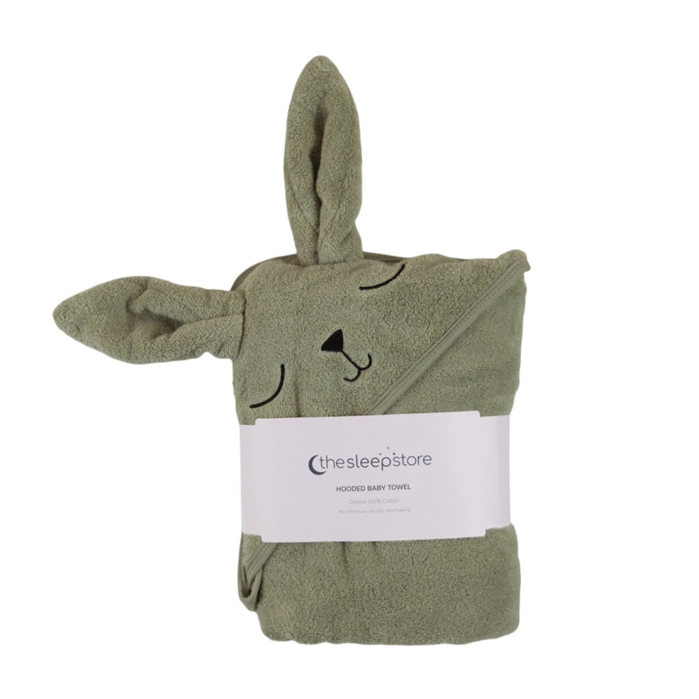 A sage green cotton hooded baby towel shaped like a bunny, wrapped in a white paper band labeled 'chesleepstore'.