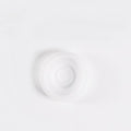 Clear silicone diaphragm disc for breast pump on a white background