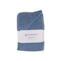 A folded dusty blue hooded cotton terry  baby towel with a white paper label from 'thesleepstore' on a plain white background.