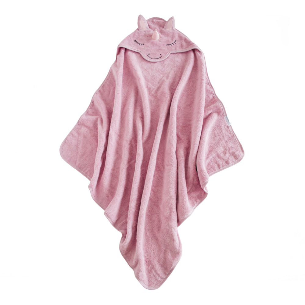 A pink plush baby cotton terry towel with a hood shaped like a unicorn, featuring embroidered closed eyes and a small horn detail, shown on a plain white background.
