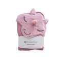 A pink hooded cotton terry baby towel shaped like a unicorn head, folded and wrapped in a white paper band labeled 'thesleepstore', on a plain white background.