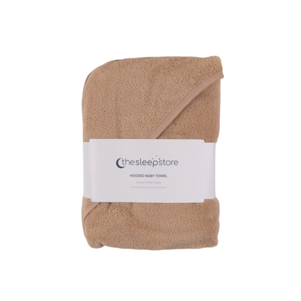 A folded tan hooded baby towel with a white paper label band reading 'thesleepstore' and 'HOODED BABY TOWEL' on a plain white background.