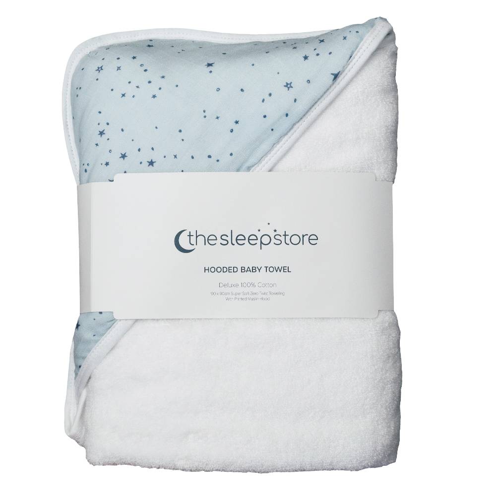A folded hooded baby towel from the brand 'the sleep store' with a white terry body, a light blue hood printed with small blue stars, and a white paper label wrapped around it.
