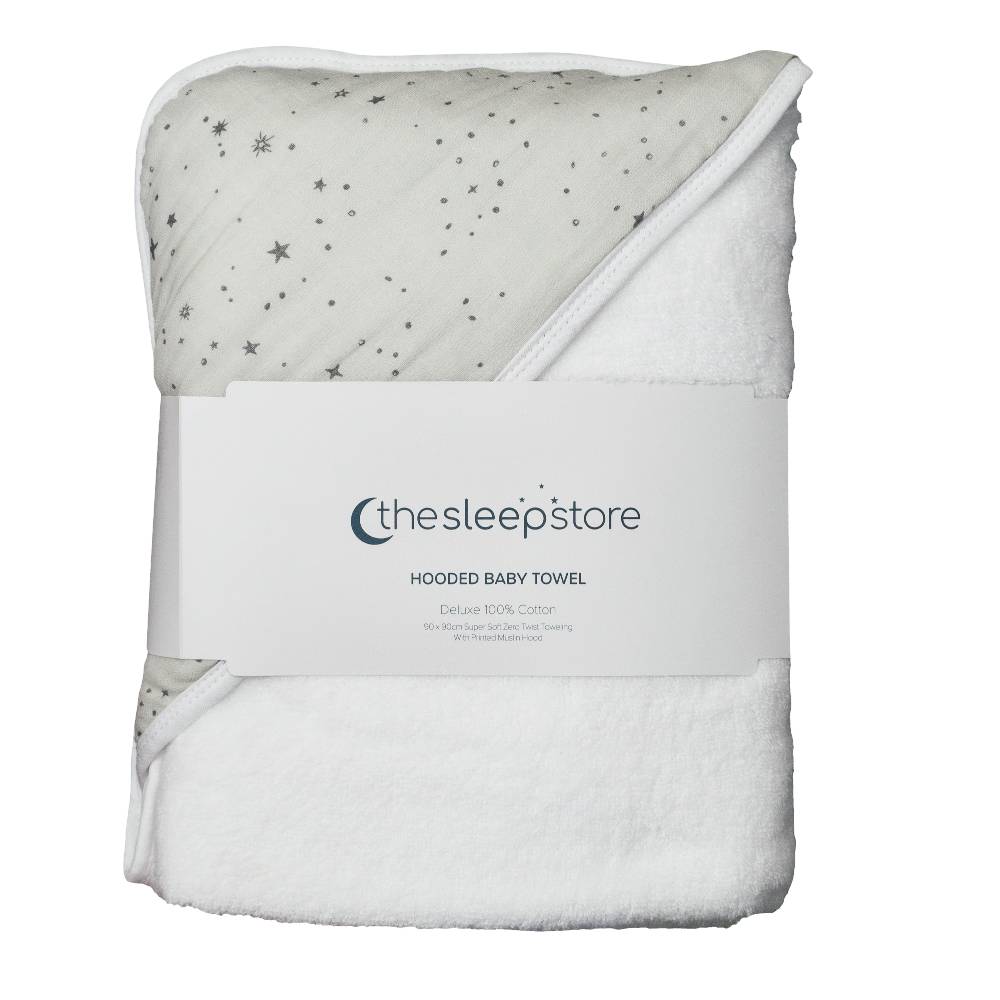 A folded white hooded baby towel with a gray star print on one side, wrapped in a white paper band labeled 'thesleepstore'.