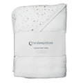 A folded white hooded baby towel with small star and moon print on one side, wrapped in a white paper band labeled 'the sleep store'.