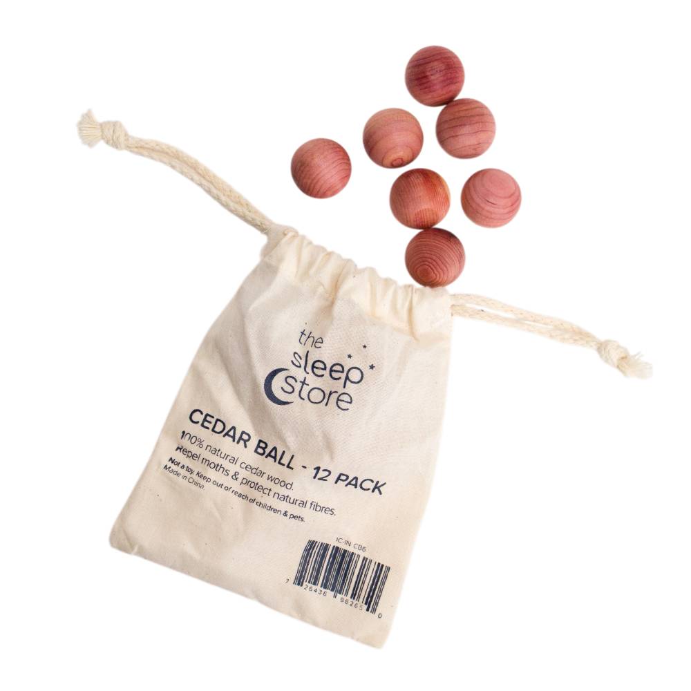 12-pack of cedar balls with a drawstring bag labeled 'The Sleep Store' on a white background.