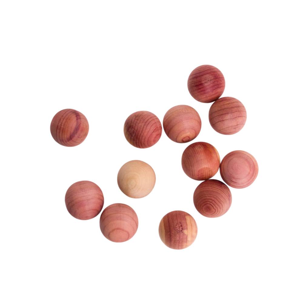 Wooden cedar wood beads of various shades on a white background