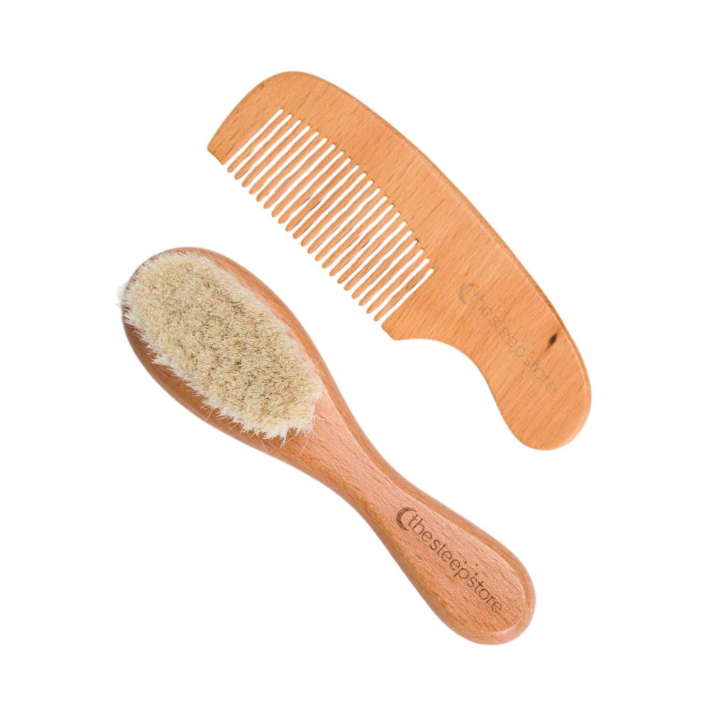 Wooden baby brush and comb set on a white background