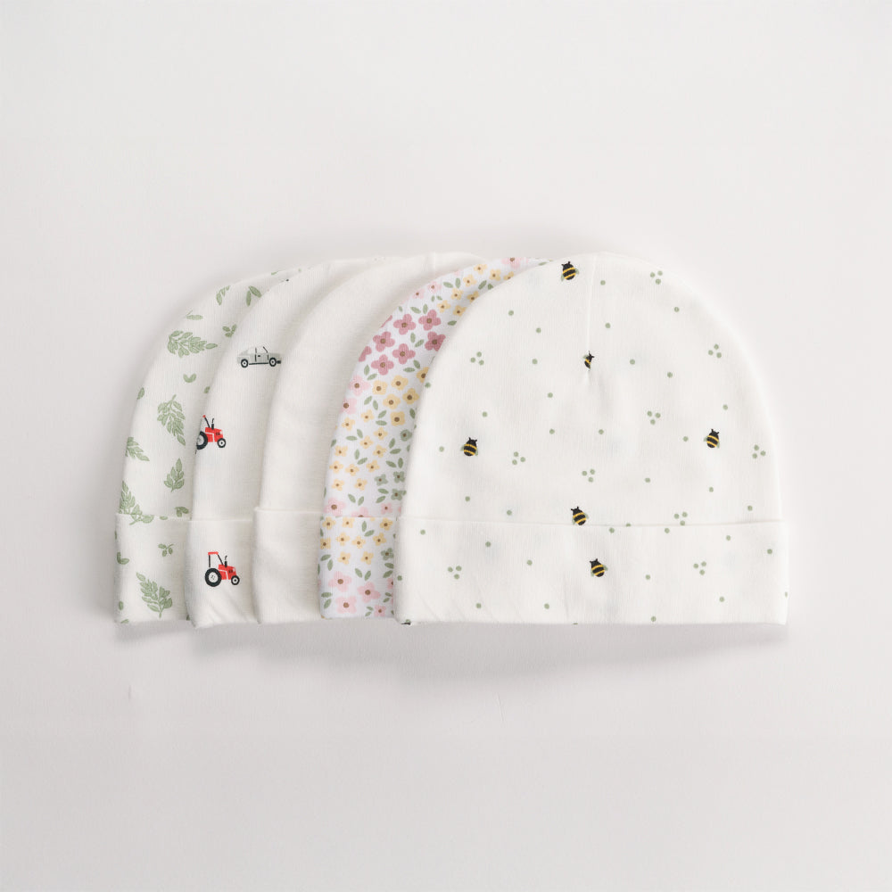 Set of four organic cotton baby beanies with different patterns on a light gray background