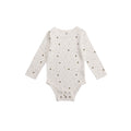 White cotton baby onesie with small bee patterns on a white background