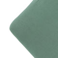 The corner of a mattress with a fern green colour fitted sheet, on a white background. 