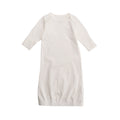 White cotton baby night gown with long sleeves on a white background