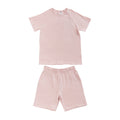 Light pink short sleeve PJs on white background. 