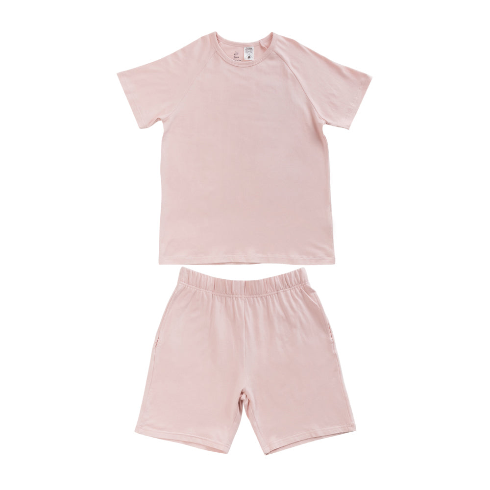 Light pink short sleeve PJs on white background. 
