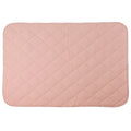 A blush pink colour quilted blanket on a white background. 