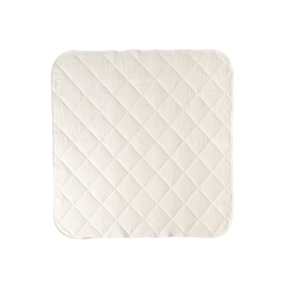 A Natural Cream quilted play mat on a white background. 