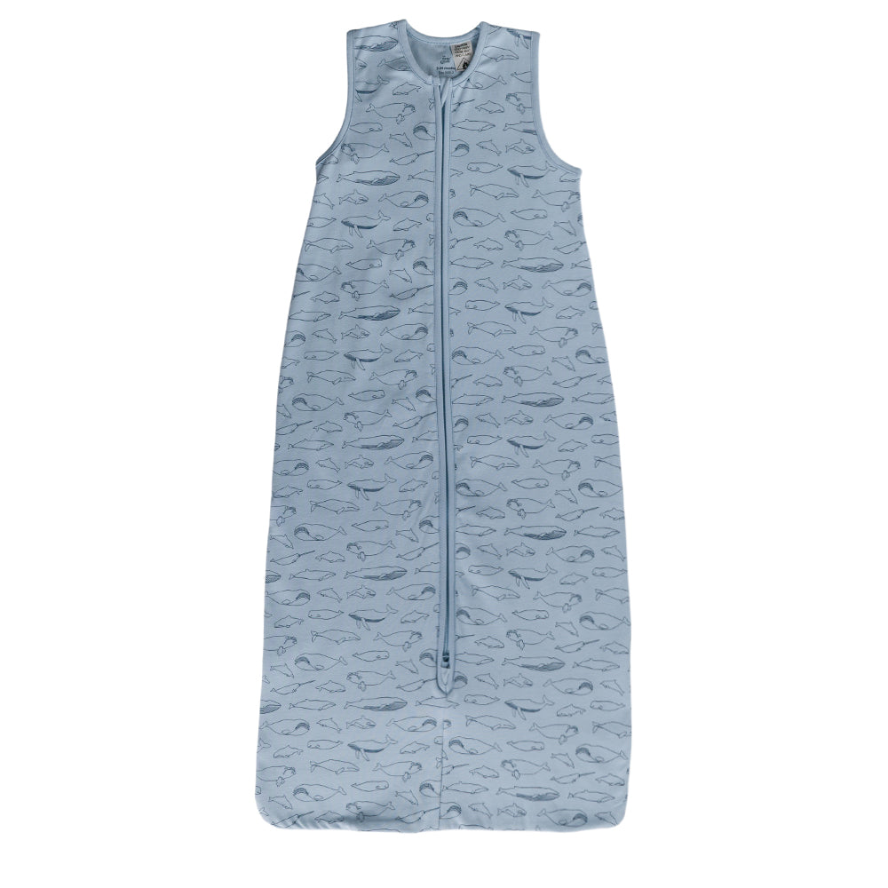 A blue sleeveless cotton baby sleep sack with a blue whales shown flat against a white background.