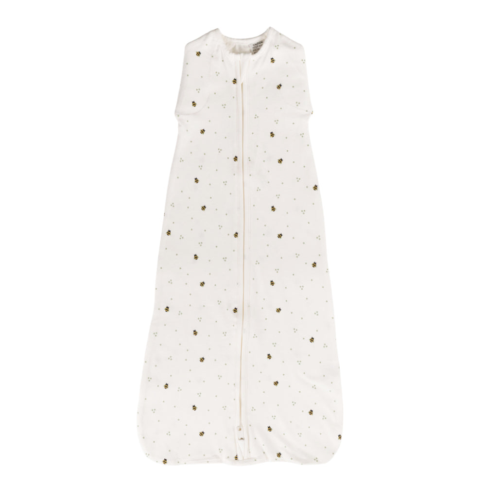 White organic cotton baby sleeping bag with bee print on a white background