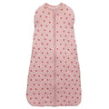 Pink baby sleeping bag with red polka dots on a white background