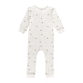 White cotton baby onesie with small patterns on a white background