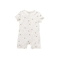 White cotton baby romper with small bees on a white background