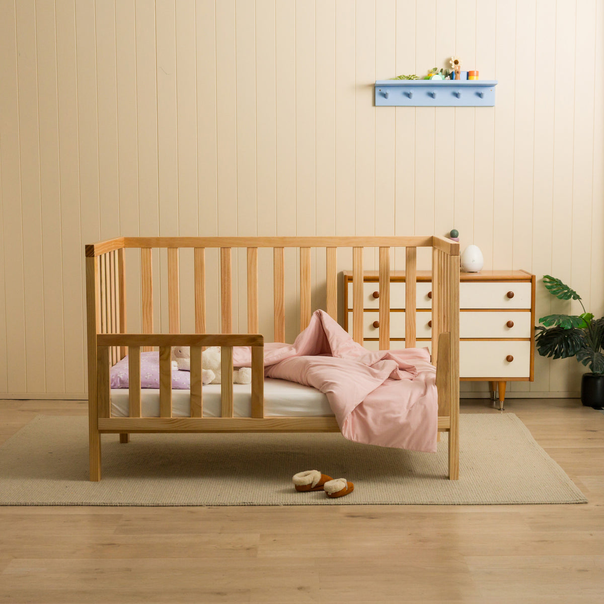 Nursery setting with a cot - featuring a blush cotton duvet cover. 
