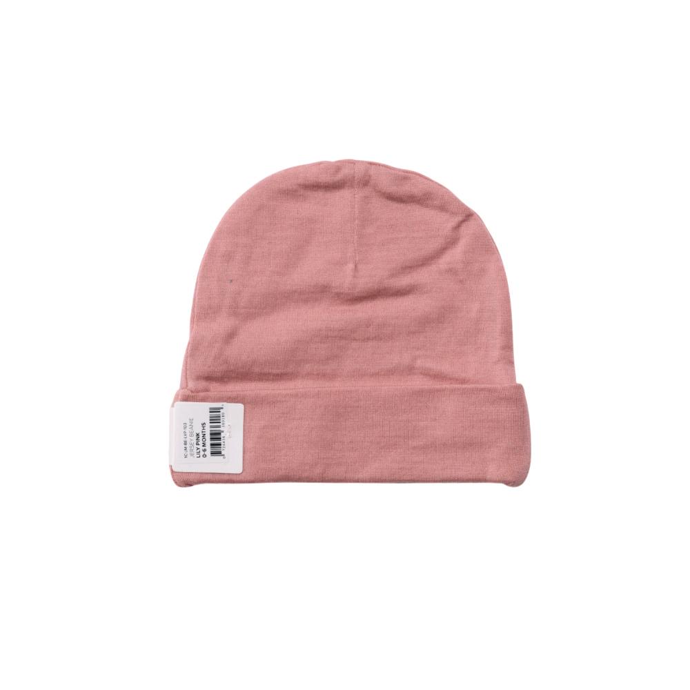 Pink merino baby beanie with a label on a white background