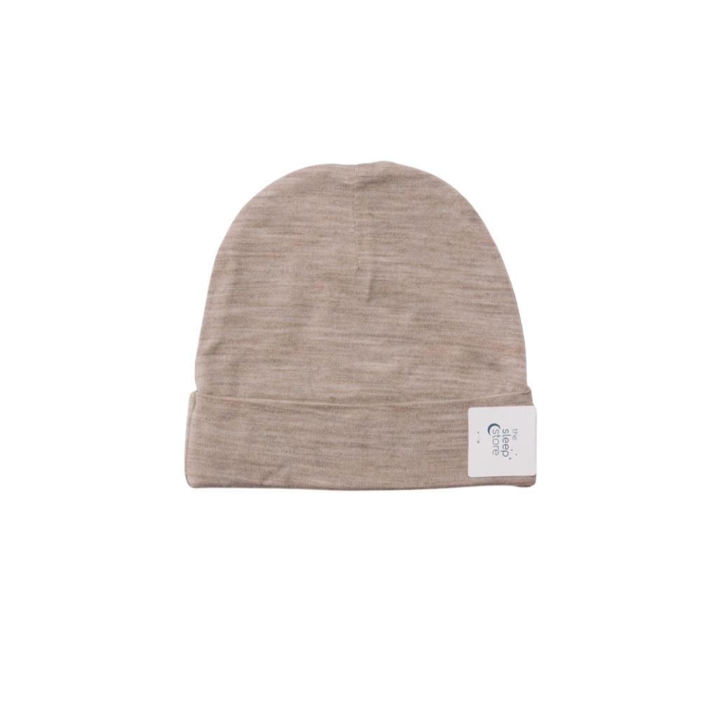 Beige baby beanie with a label on a white background