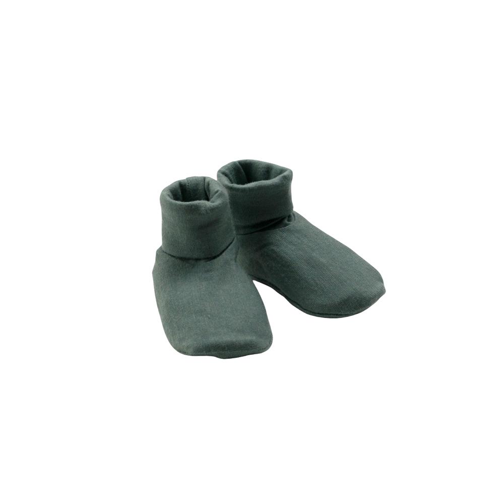Pair of green baby booties on a white background