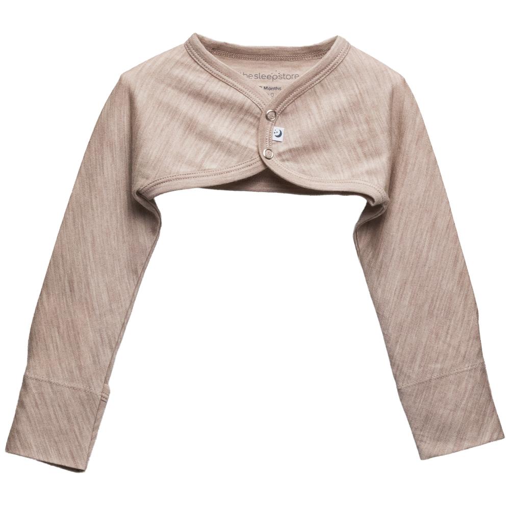 A long-sleeve jersey merino cosy arm warmers in a beige marl color, featuring a short button-up front panel  shown on a plain white background.