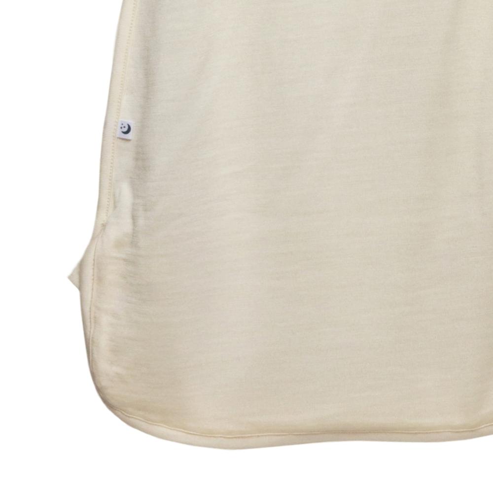 close up of label on beige Merino Jersey Zip Swaddle on white background