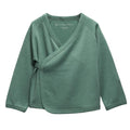 A sage green jersey merino long-sleeve baby kimono wrap top with a V-neck and button closure, laid flat on a white background.