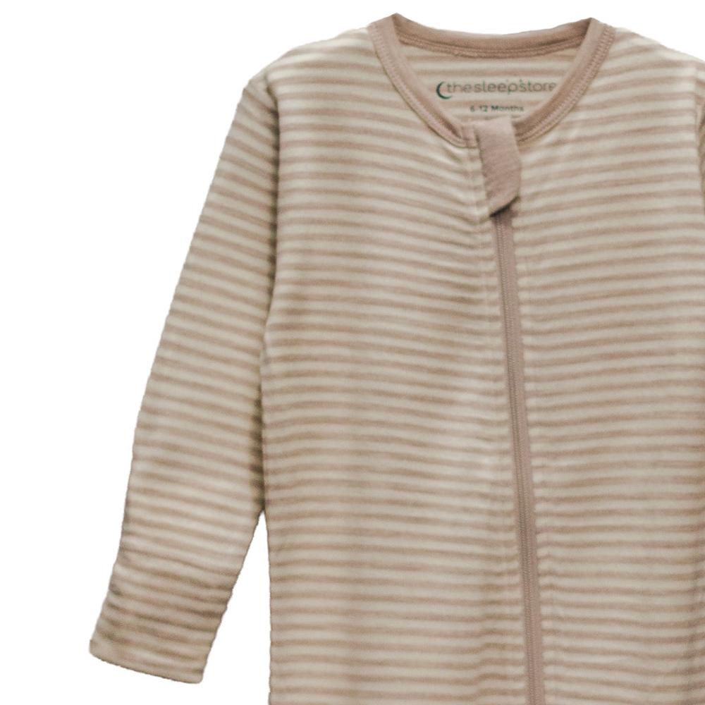 Close-up of beige striped baby zipsuit on a white background