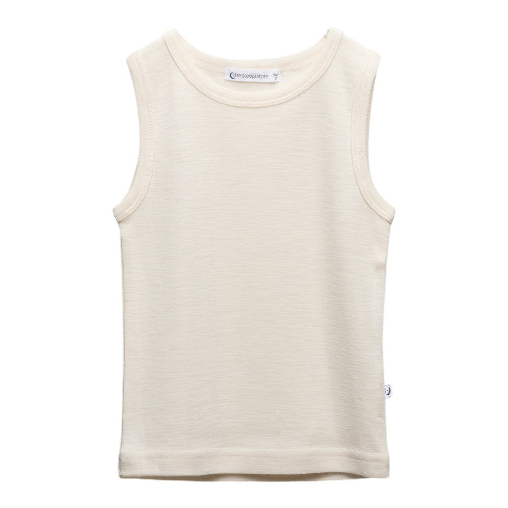 A sleeveless cream-colored tank top in deluxe merino rib fabric with a crew neck, laid flat against a solid white background. The brand name 'The Sleep Store' is visible on the inner neck label.