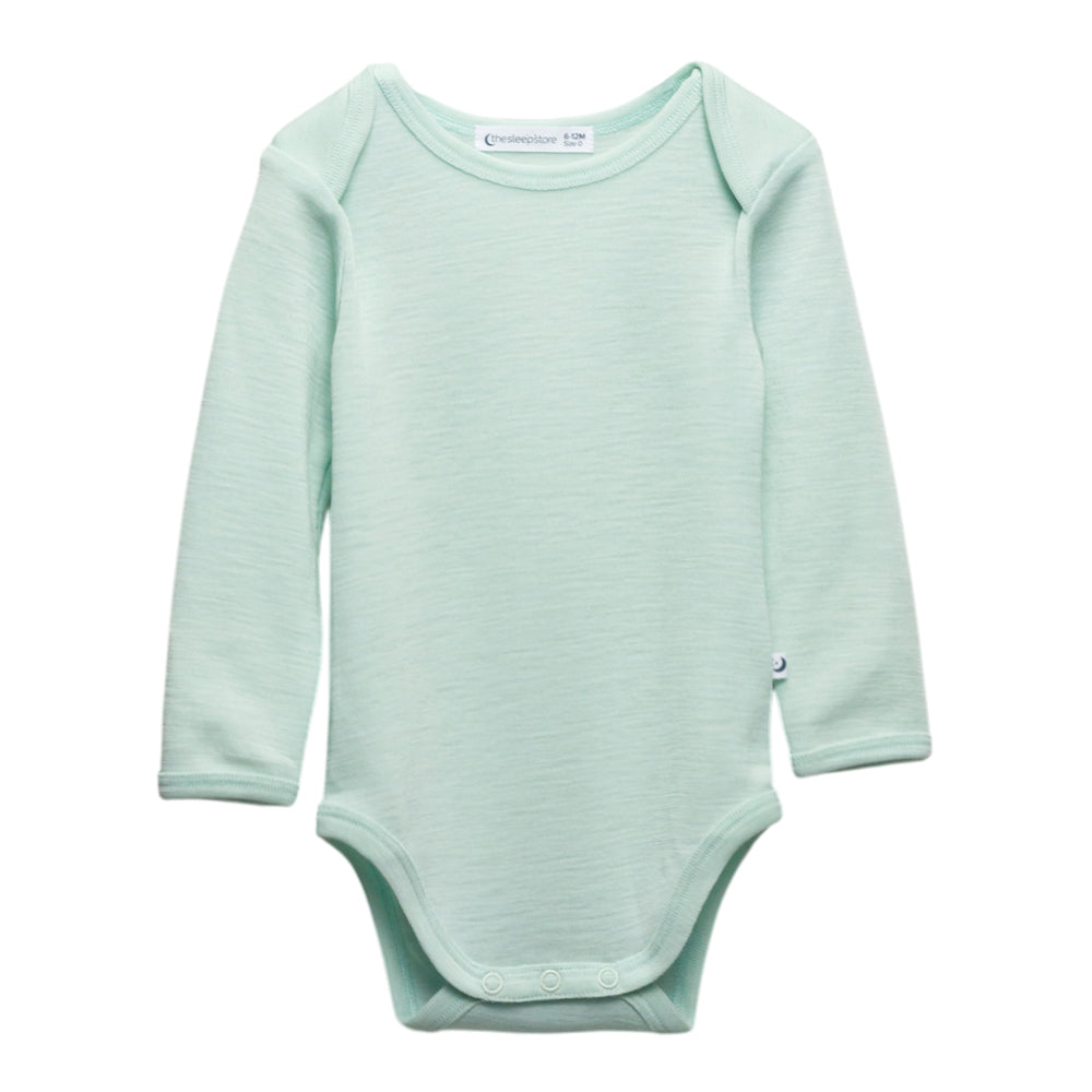 A long-sleeve deluxe merino rib baby bodysuit in a light mint green color, shown flat against a solid white background.