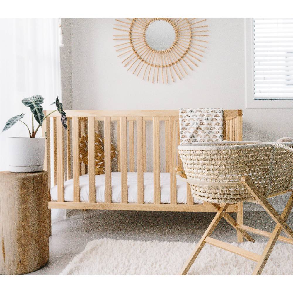 Neutral nursery with a cot and moses basket on a stand