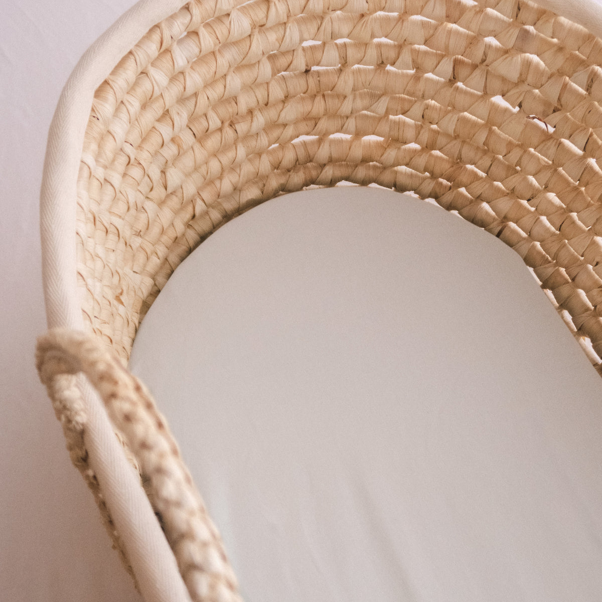 Close up of moses basket with cotton fitted sheet
