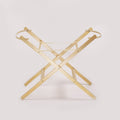 A light natural wood folding table base or stand with a minimalist X-frame design and circular top rings, shown on a clean off-white background.
