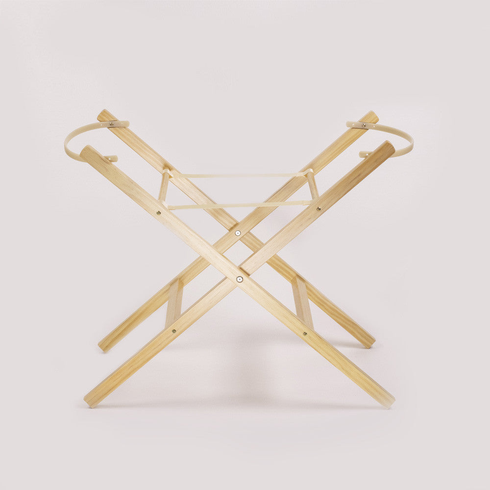 A light natural wood folding table base or stand with a minimalist X-frame design and circular top rings, shown on a clean off-white background.