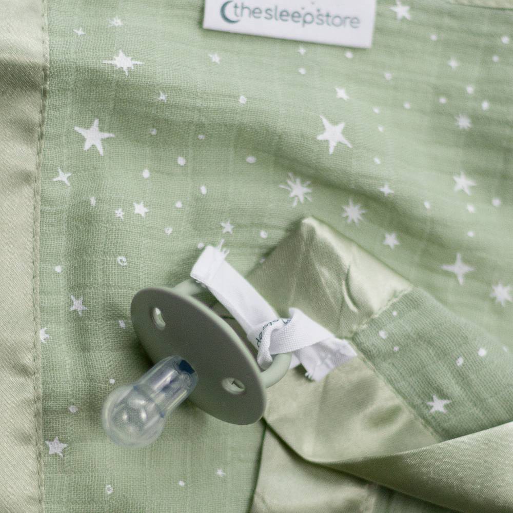 Pacifier attached to cotton muslin comorter