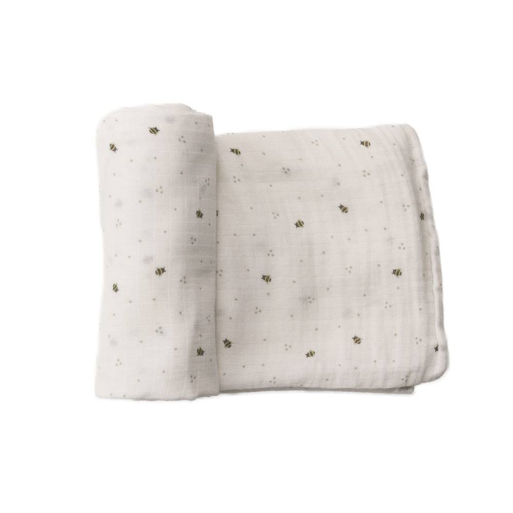 Muslin swaddling wrap with small bee patterns on a white background