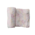 Floral-patterned baby muslin swaddling blanket on a white background