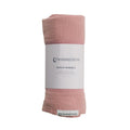 Pink cotton muslin swaddle blanket with 'thesleepstore' label on a white background