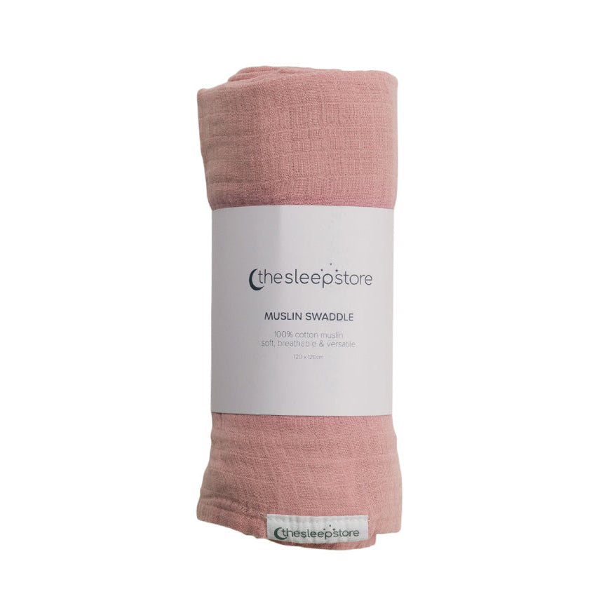 Pink cotton muslin swaddle blanket with 'thesleepstore' label on a white background