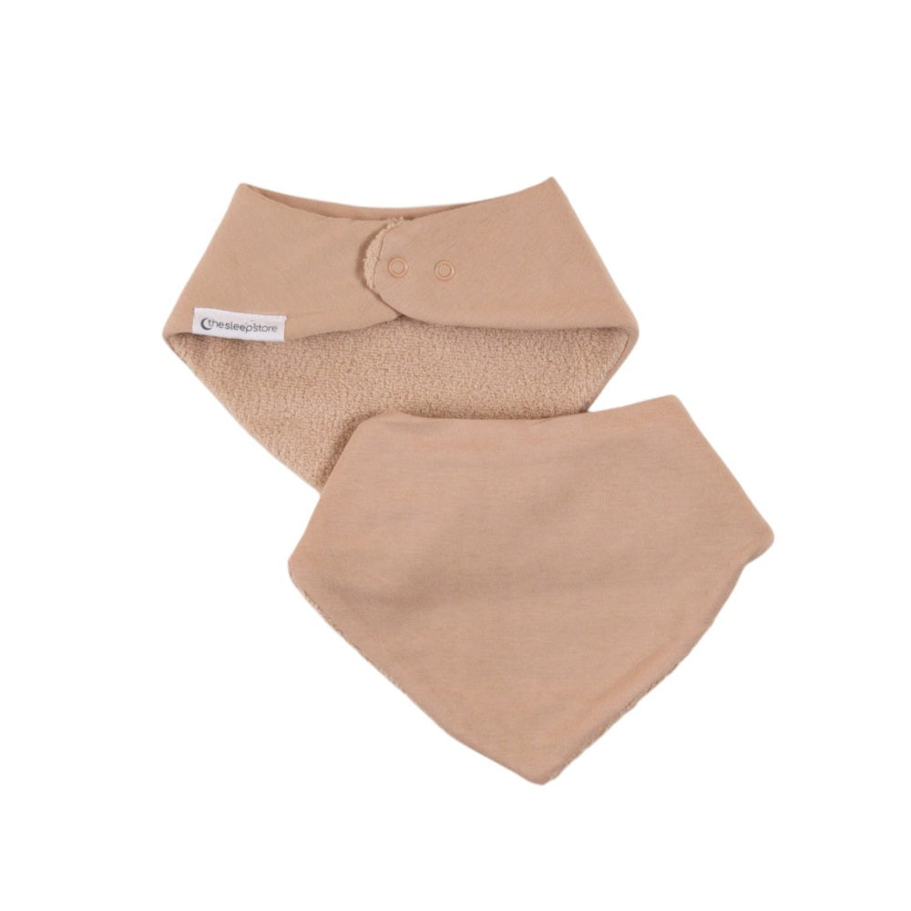Two beige bandana baby bibs on a white background