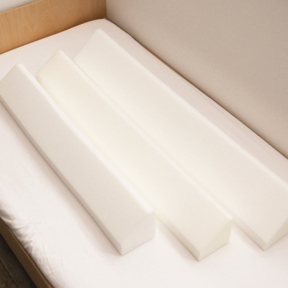 Close-up of a mattress with 3 bed different size bed bumpers - small, big and bigger. 